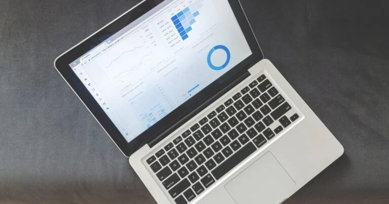 Finance and engineering colleagues reviewing a cloud cost dashboard on a laptop