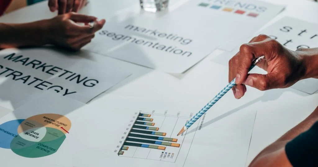 B2B marketing team reviewing customer data and campaign dashboards in a meeting room
