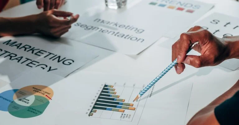B2B marketing team reviewing customer data and campaign dashboards in a meeting room