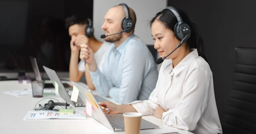 Office worker using a headset and laptop for a cloud-based business phone call
