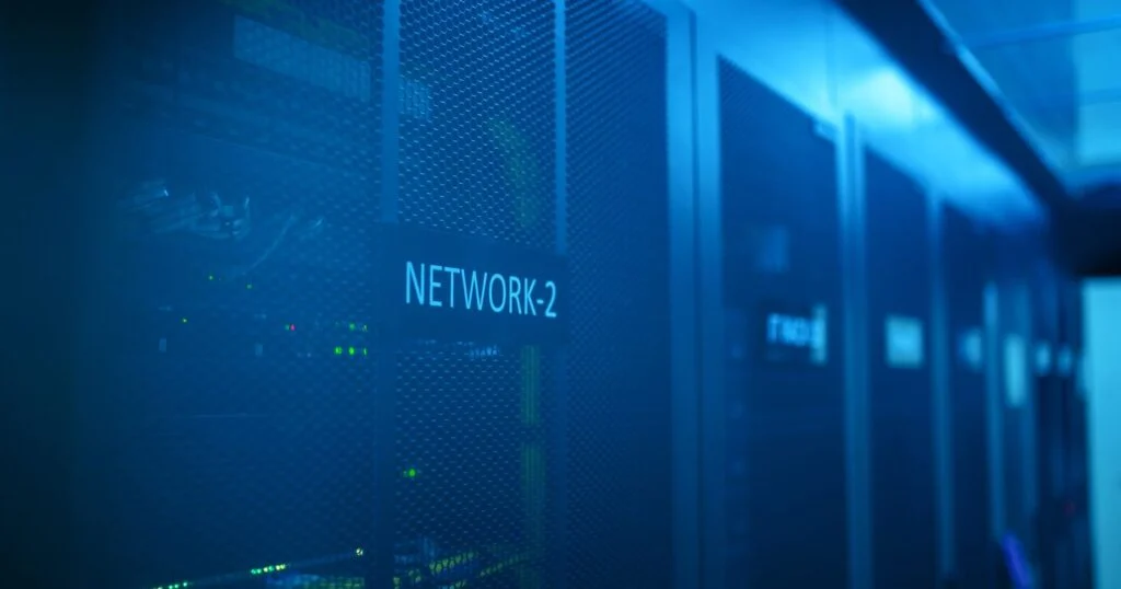 IT security team reviewing network access policies on screens in an office